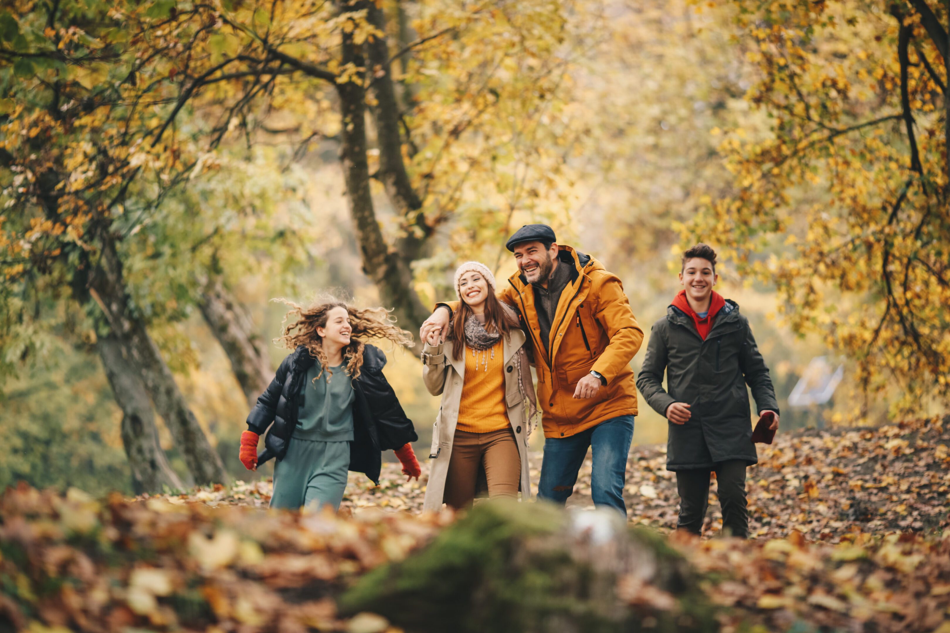 Family enjoying a walk in the autumn woods.